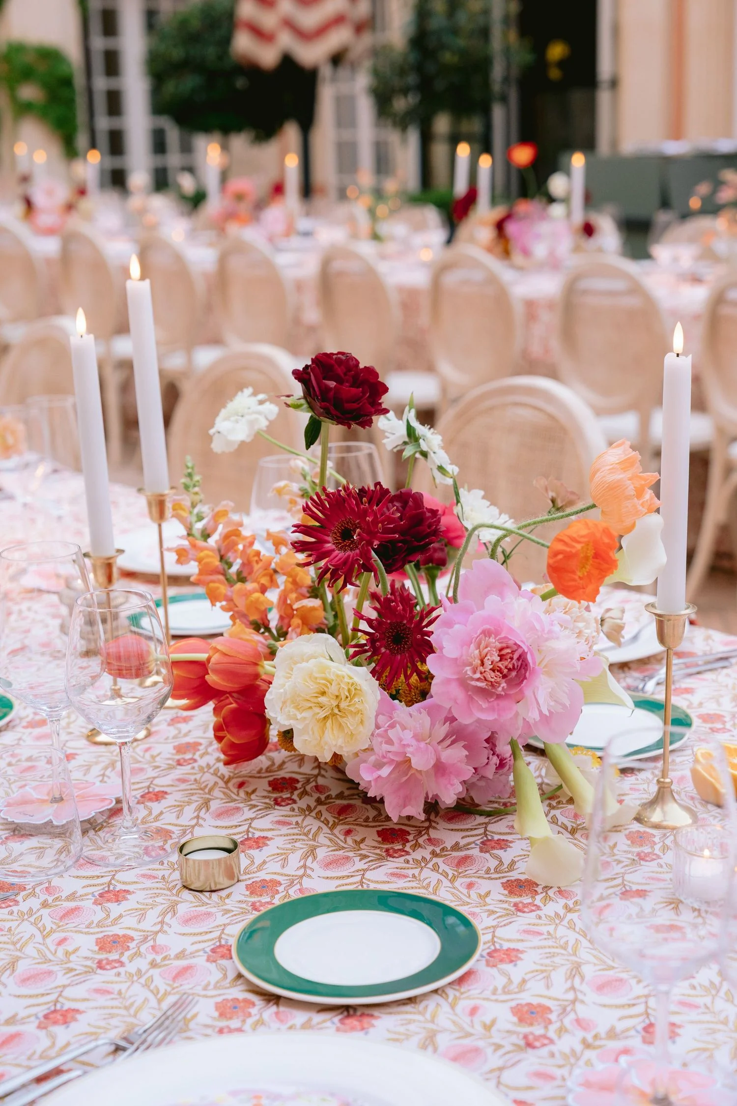Long reception table with hot pink and coral centrepieces and tapered candles